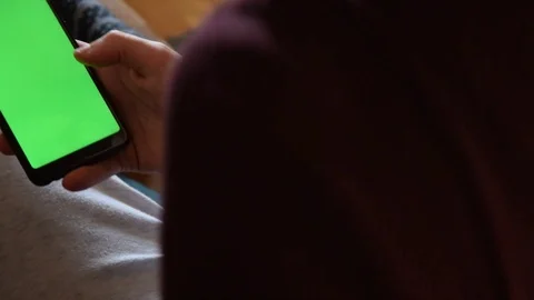 Scrolling on the green screen on couch Stock Footage 129767970