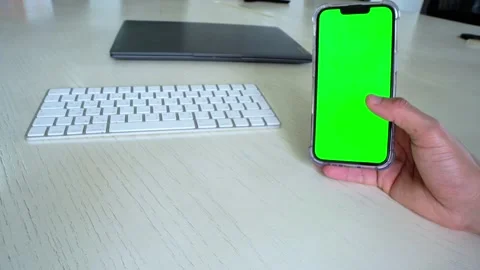 Scrolling on Green Screen Smartphone Over Keyboard – Interactive Office Mockup Stock Footage 311903632