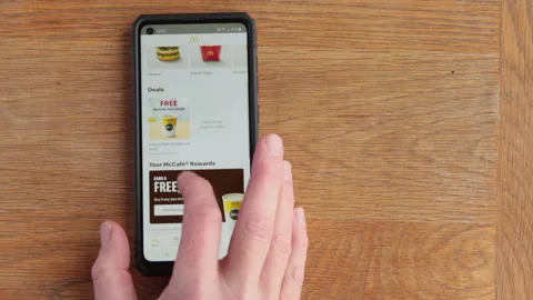 Scrolling McDonalds menu on android phone in the time of Covid in the UK Stock Footage 147265473