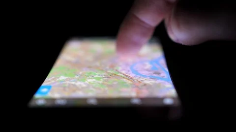 Scrolling Online Navigation Map on Smartphone Touchscreen in the Dark Stock Footage 104050052