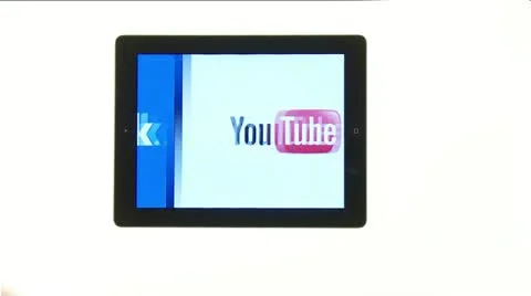Scrolling over facebook, twitter and you tube on new ipad 4 screen Stock Footage 12617550