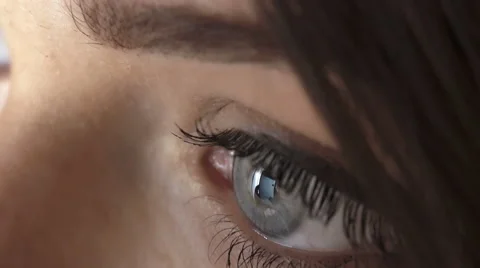 Scrolling the pages of facebook: reflection in the eyes of a young woman  Stock Footage 68544967