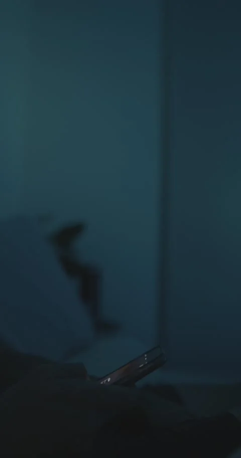 Scrolling on a phone blue light Stock Footage 240082848