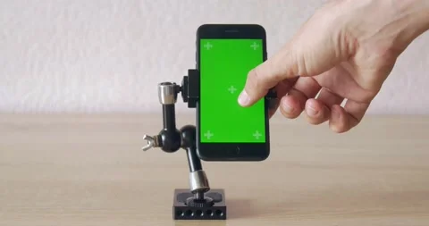 Scrolling phone screen on weird holder - green screen Stock Footage 131431480