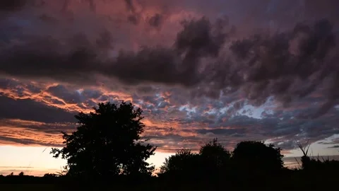 Scrolling pink clouds in a sunset sky. Timelapse. Stock Footage 224023669