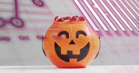 Scrolling pink code initiating node bar overlays on jack-o-lantern candy bucket Video stock 317835417