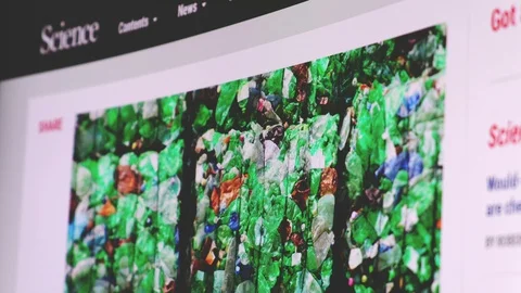 Scrolling Science Magazine article about new mutant enzyme to recycling plastic Stock Footage 128184792