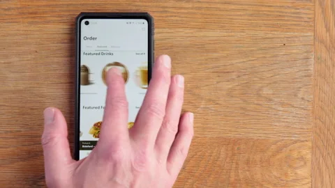 Scrolling Starbucks menu on android phone in the time of Covid in the UK Stock Footage 147269062
