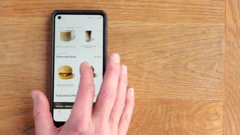Scrolling Starbucks menu on android phone in the time of Covid in the UK Stock Footage 147269470