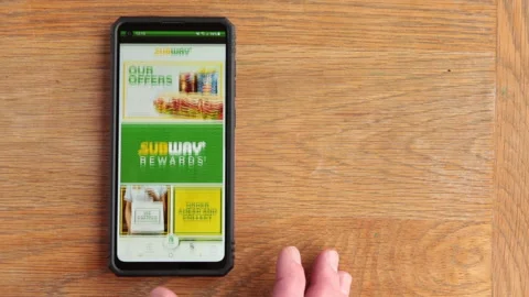 Scrolling subway menu on android phone in the time of Covid in the UK Stock Footage 147264552