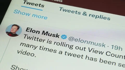 Scrolling through account of Elon Musk on Twitter social media app on a tablet Stock Footage 227743706