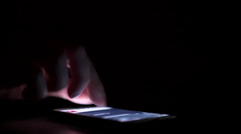 Scrolling through a file on smart phone dark room shot 4k Video stock 59240050