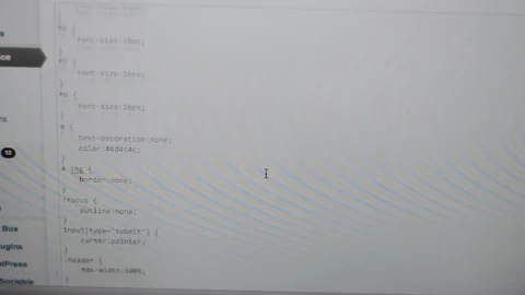 Scrolling through a page of css on a web developers computer screen Stock Footage 141558804