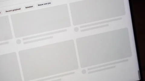 Scrolling through the popular Youtube app feed on a laptop screen. Stock Footage 304170295
