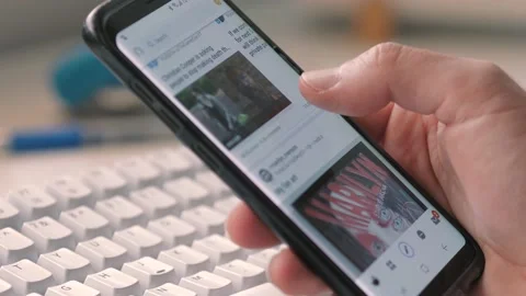 Scrolling Through a Reddit Thread on a Smartphone Closeup Video stock 132041987