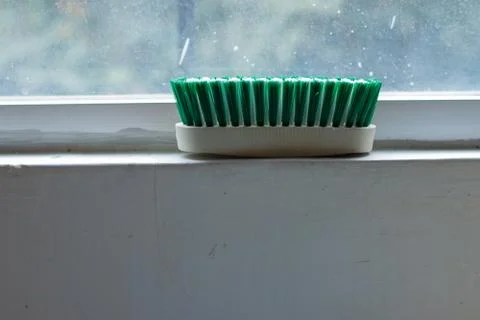 Scrub Brush on Window Edge Stock Photos