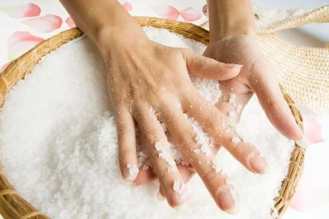 Scrub hands with salt Stock Photos