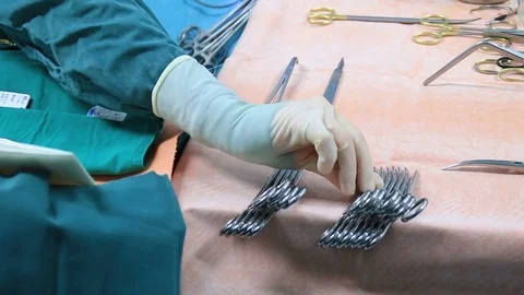 Scrub nurse preparing tools for operation Video stock 72405654