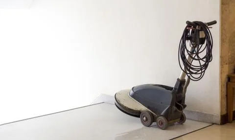 Scrubber machine is placed in front of the ladder and wait staff cleaning in Stock Photos