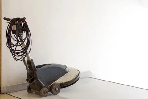 Scrubber machine is placed in front of the ladder and wait staff cleaning in Stock Photos