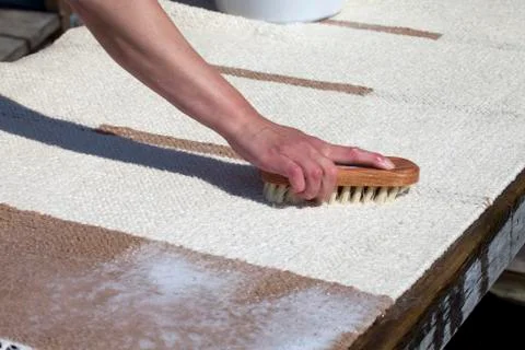 Scrubbing carpet on the dock Stock Photos
