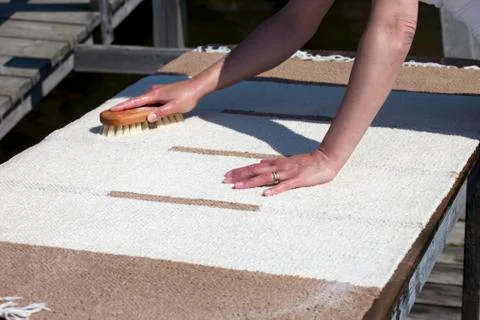 Scrubbing carpet on the dock Stock Photos