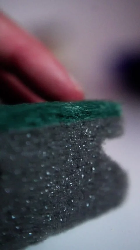 Scrubbing crumbs from kitchen surface thoroughly, removing food debris from Stock Footage 321611515