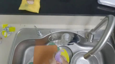 Scrubbing a Cutting Board, Knife, and Bowl with a Sponge and Soap Foam Stock Footage 343148466