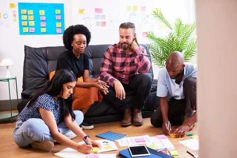 Scrum team brainstorms for mobile app idea, UX design and planning development Stock Photos