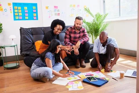 Scrum team brainstorms for mobile app idea, UX design and planning development Stock Photos