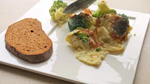 Scrumptious breakfast of omelette and broccoli beautifully presented on plate Stock Footage 267699641