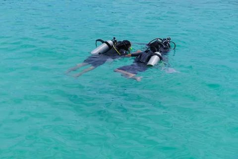 Scuba dive training in the sea with a instructor teaching students Stock Photos