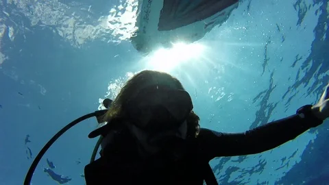 Scuba diver almost at the surface near the dive boat great visibility Video stock 123077919