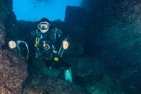 A scuba diver blows a bubble ring. Stock Photos