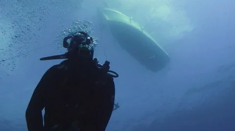 Scuba diver, boat in background, surface Stock Footage 42889571