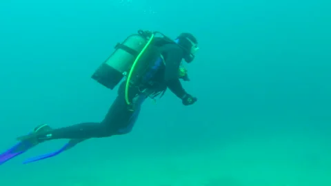 Scuba diver check his dive computer in the Mediterranean Sea Stock Footage 133609044