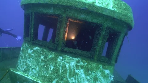 Scuba Diver is Checking the Ship Wreck with Light Stock Footage 121879961