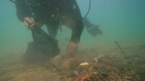 Scuba Diver Cleans The Bottom of the Sea from Garbages Stock Footage 144844366