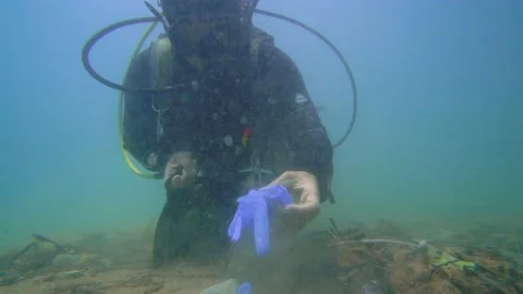 The Scuba Diver Cleans Single Use Plastics Under the Sea, 4k Stock Footage 144845494