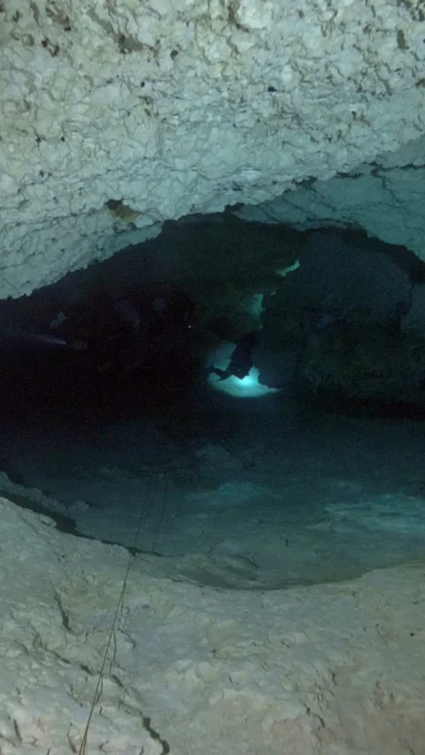 Scuba diver crossing a low limestone passage Stock Footage 341361702