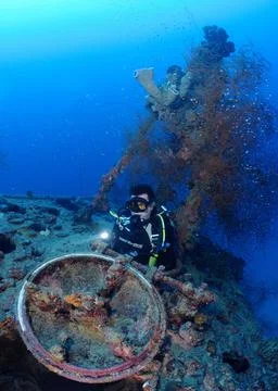 Scuba diver exits hatch of sunken Japanese submarine I-169, Chuuk, Micronesia Stock Photos