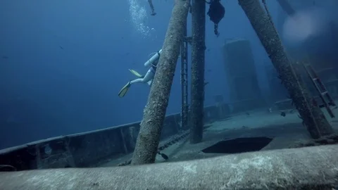 Scuba Diver Explores Sunken Ship Stock Footage 75798750