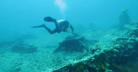 Scuba Diver Exploring Big Ship Wreck. The ship was Japanese Stock Footage 269665745