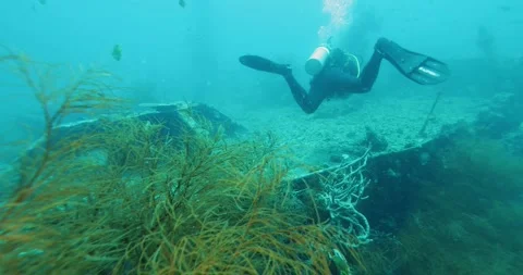 Scuba Diver Exploring Big Ship Wreck. The ship was Japanese Stock Footage 270651171