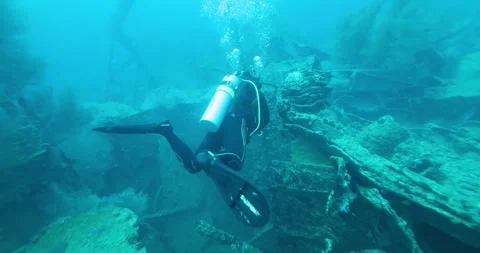 Scuba Diver Exploring Big Ship Wreck. The ship was Japanese Stock Footage 271074830