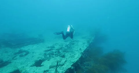 Scuba Diver Exploring Big Ship Wreck. The ship was Japanese Stock Footage 274661934