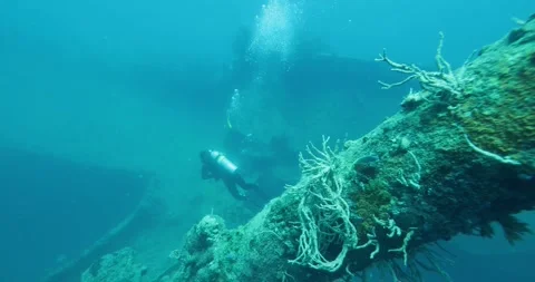 Scuba Diver Exploring Big Ship Wreck. The ship was Japanese Stock Footage 280458909