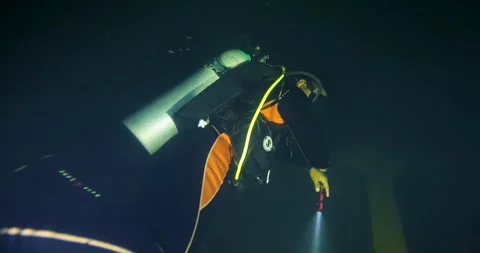 Scuba Diver Exploring Inside Big Ship Wreck in darkness. Stock Footage 265219300