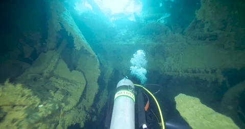 Scuba Diver Exploring Inside Big Ship Wreck in darkness. Stock Footage 267184373