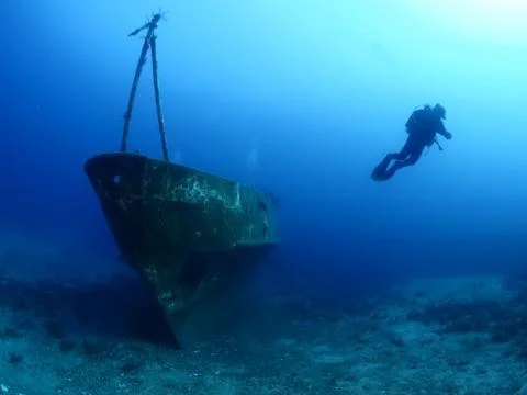 Scuba diver exploring ship wreck photo shipwreck Stock Photos